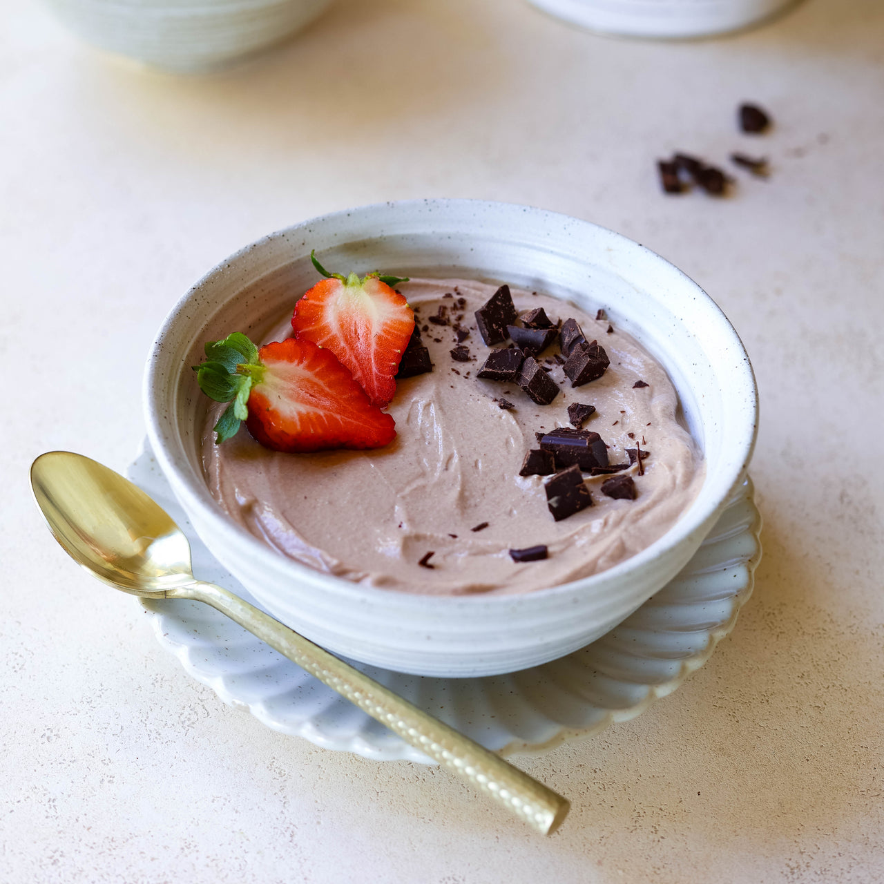 High Protein Chocolate Mousse in bowl with fresh strawberries