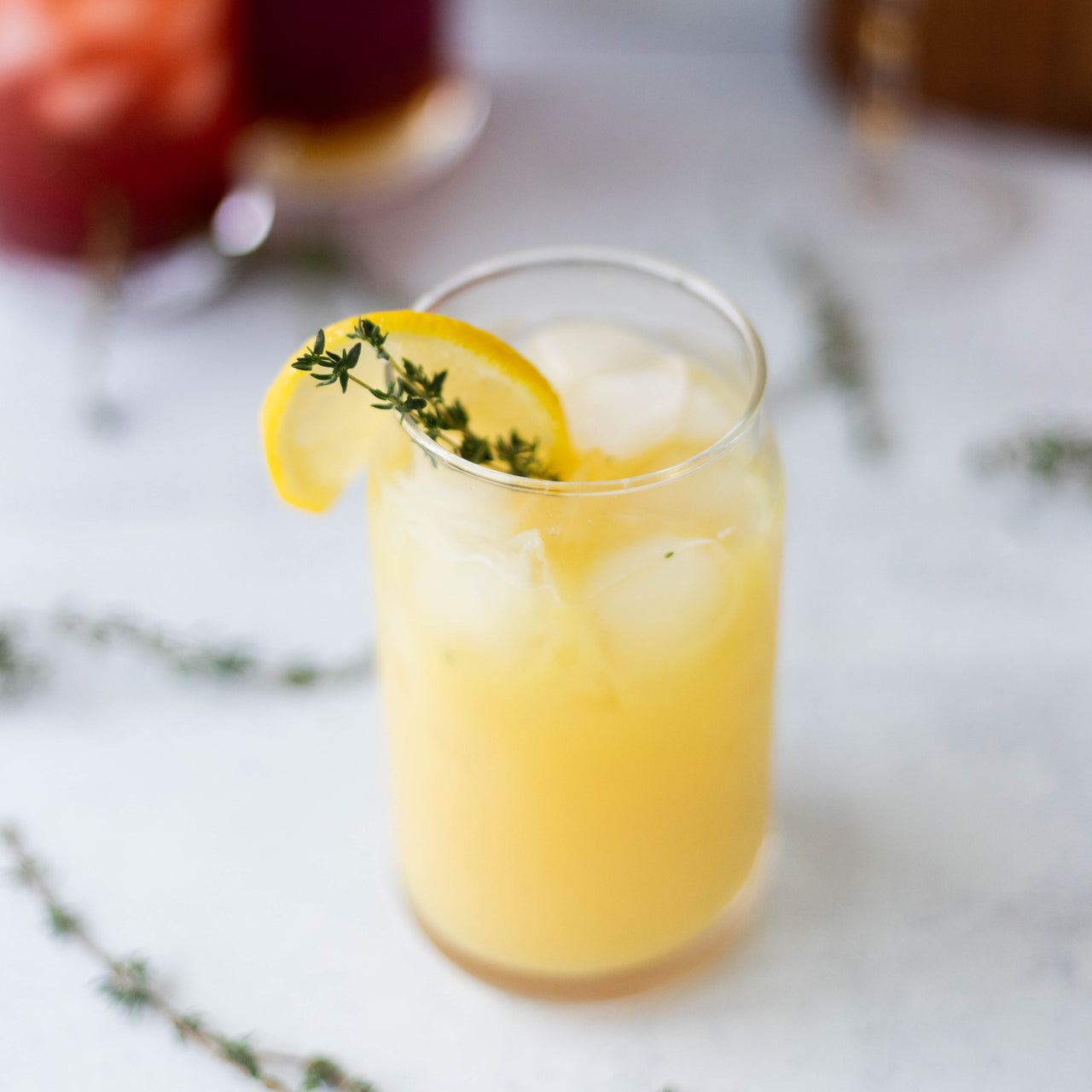 Ginger Thyme Tonic in glass with lemon wedge