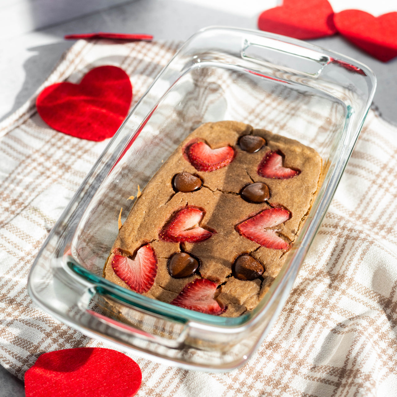 Chocolate Strawberry Baked Oats in dish with paper hearts