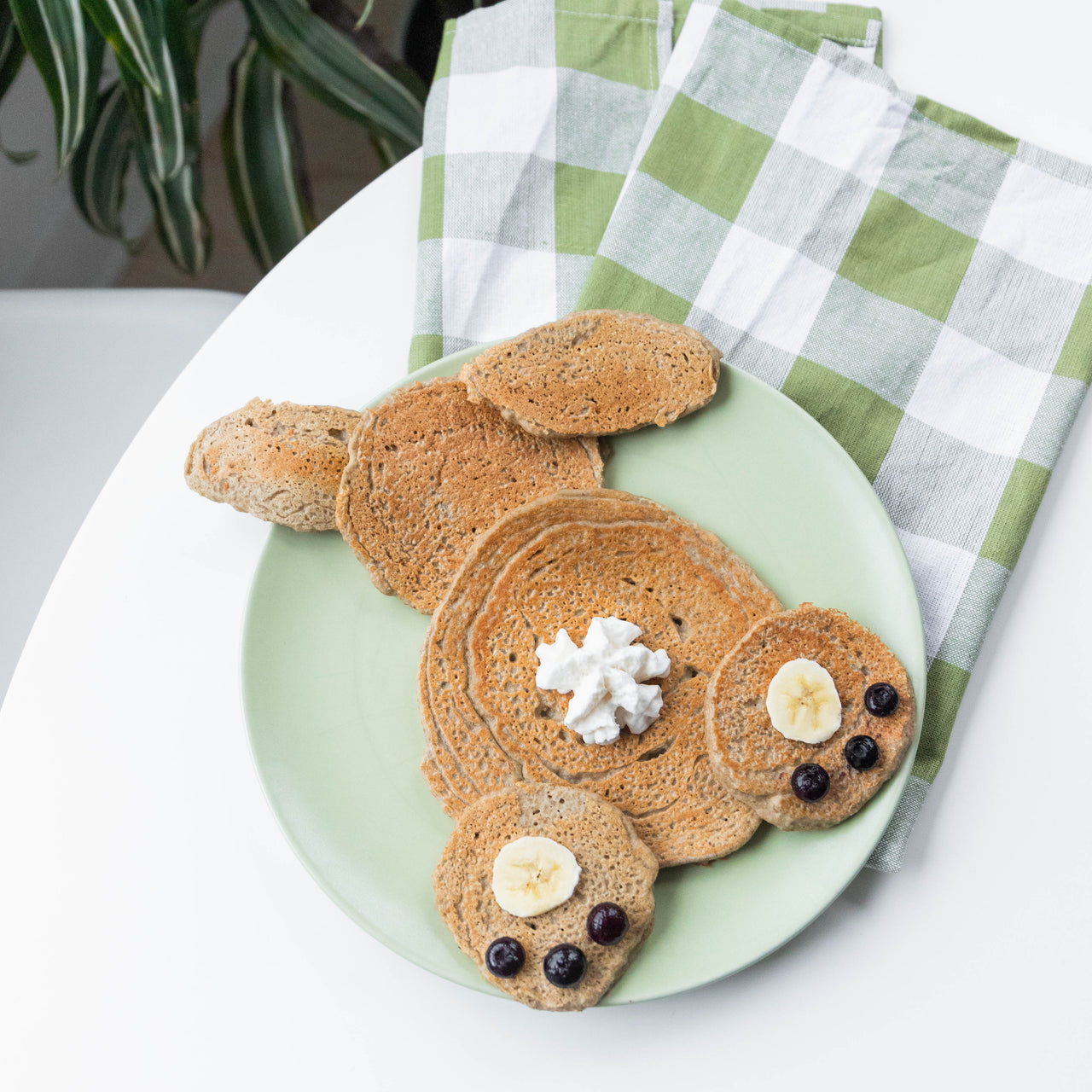Bunny shaped pancakes on green plate