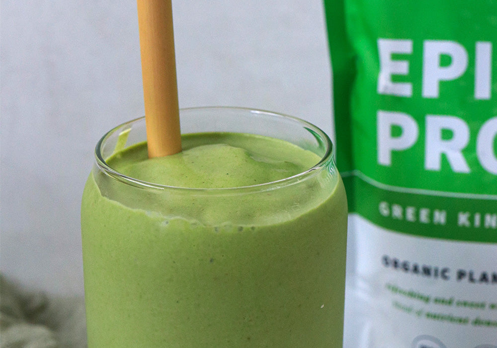 Strawberry Pineapple Green Smoothie in glass with straw