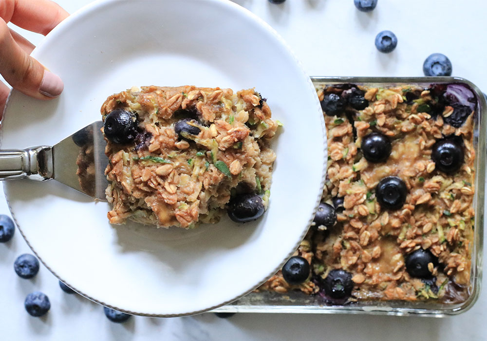 Berry Oat Bake in pan being served on plate