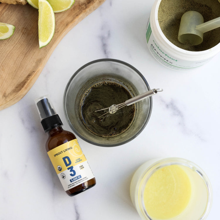 Vitamin D3 Spray in the kitchen with green juice