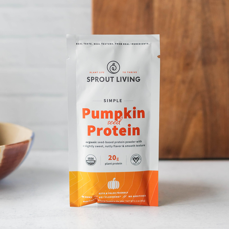 Sprout Living pumpkin seed protein package on a white surface with a wooden background