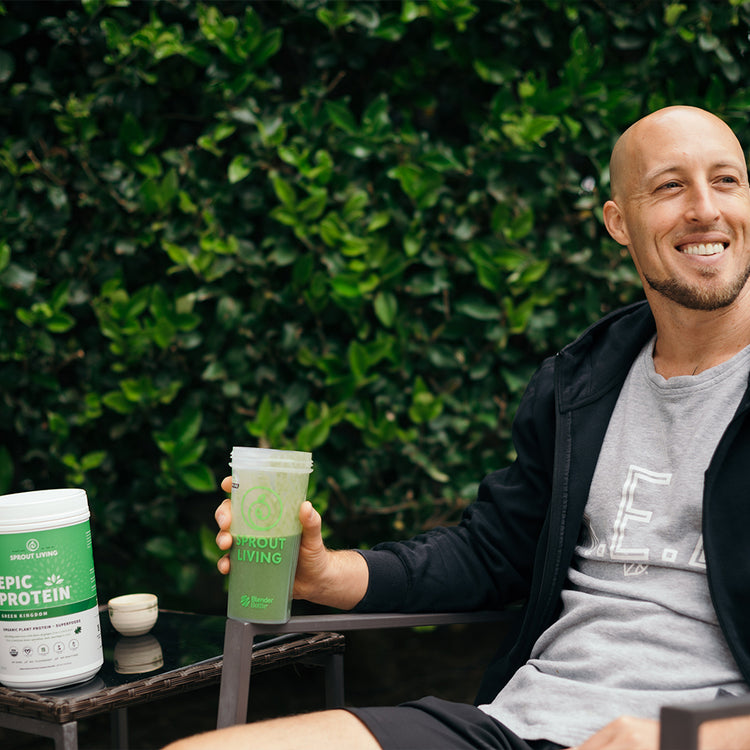 athletic man enjoying protein drink outside