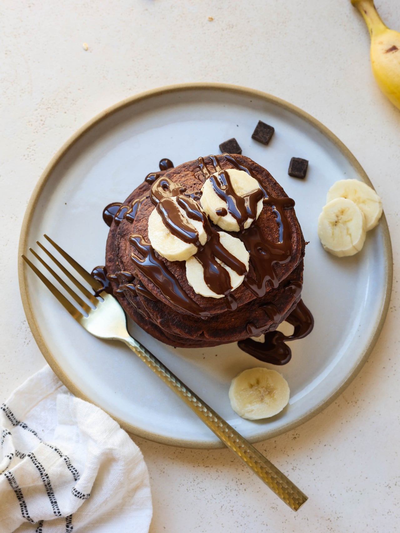 Chocolate Maca Protein Pancakes with bananas on plate