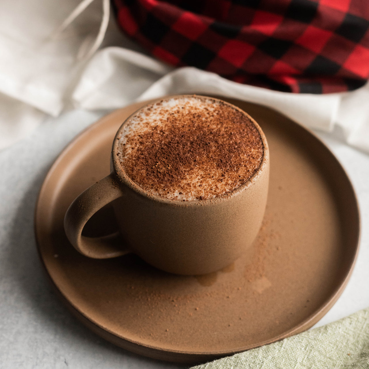 Superfood Hot Cocoa in brown mug on brown plate