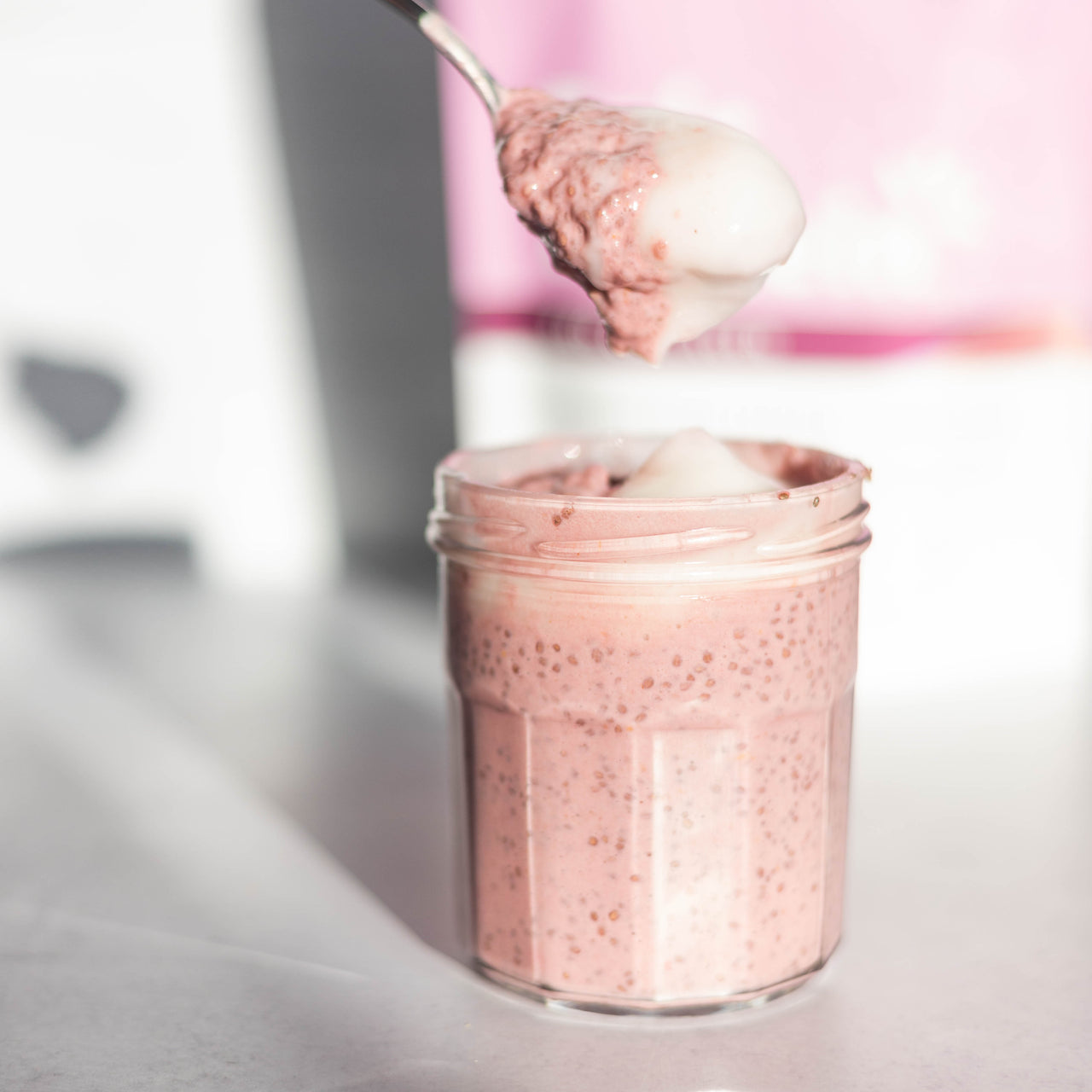 Raspberry Chia Pudding in jar with spoon