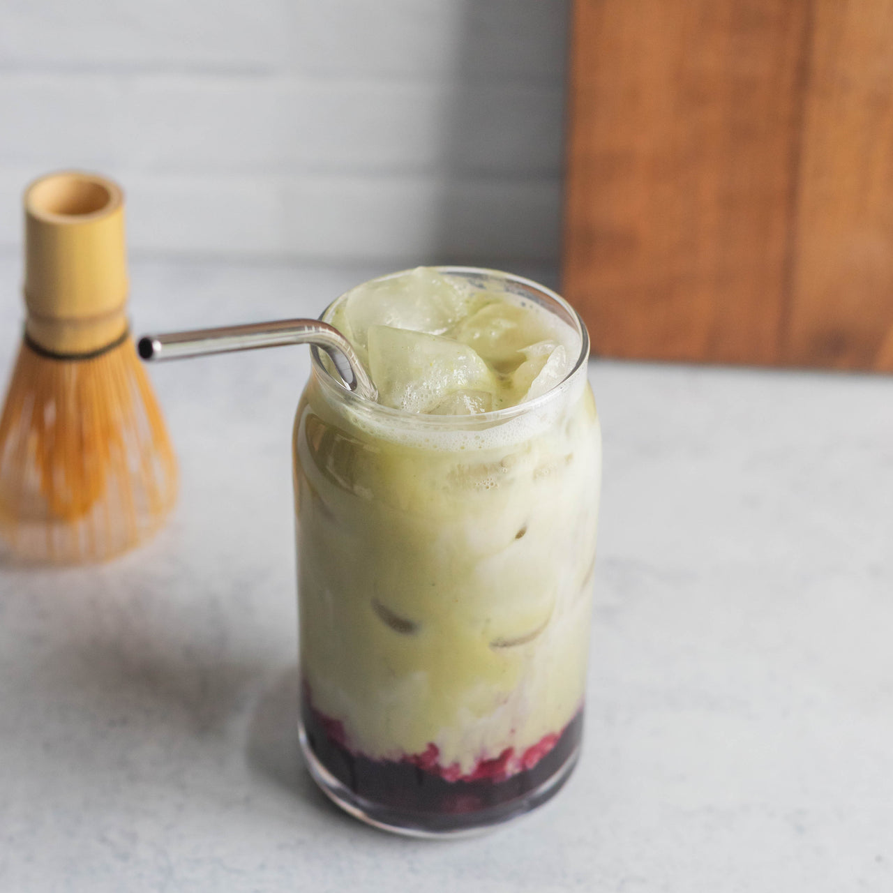 Protein Blueberry Matcha Latte in glass with metal straw