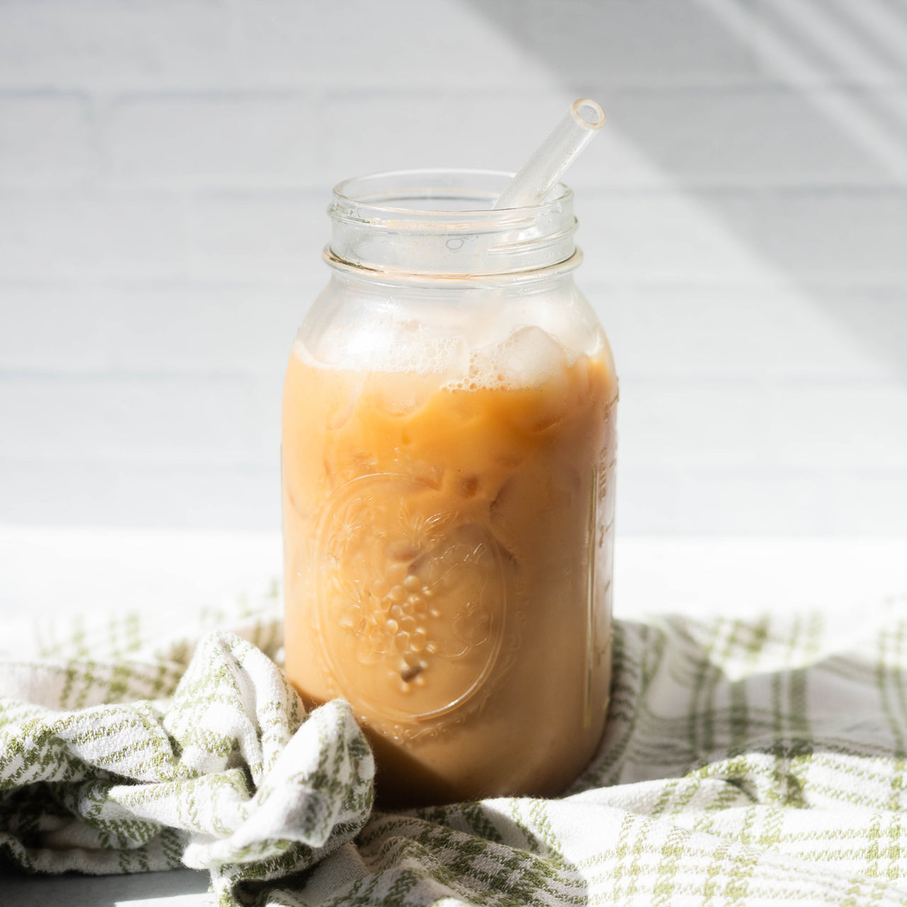 Pumpkin Spice Creamer in Glass of Coffee With Straw