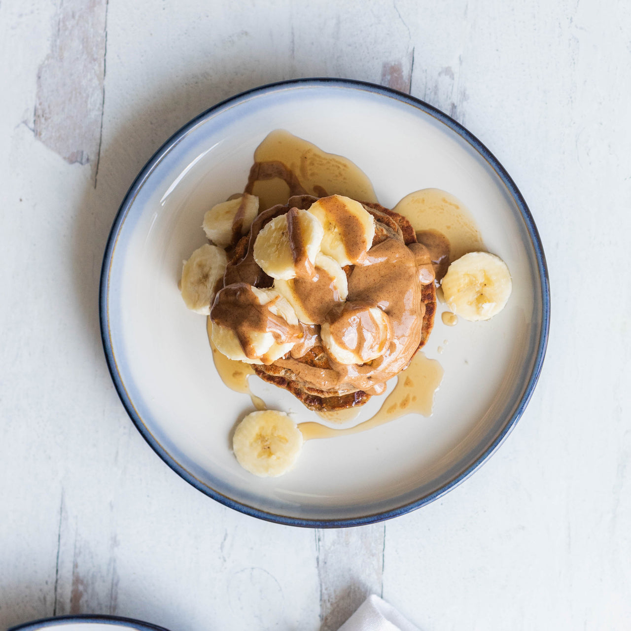 Protein-Packed Banana Pancakes on plate with banana slices