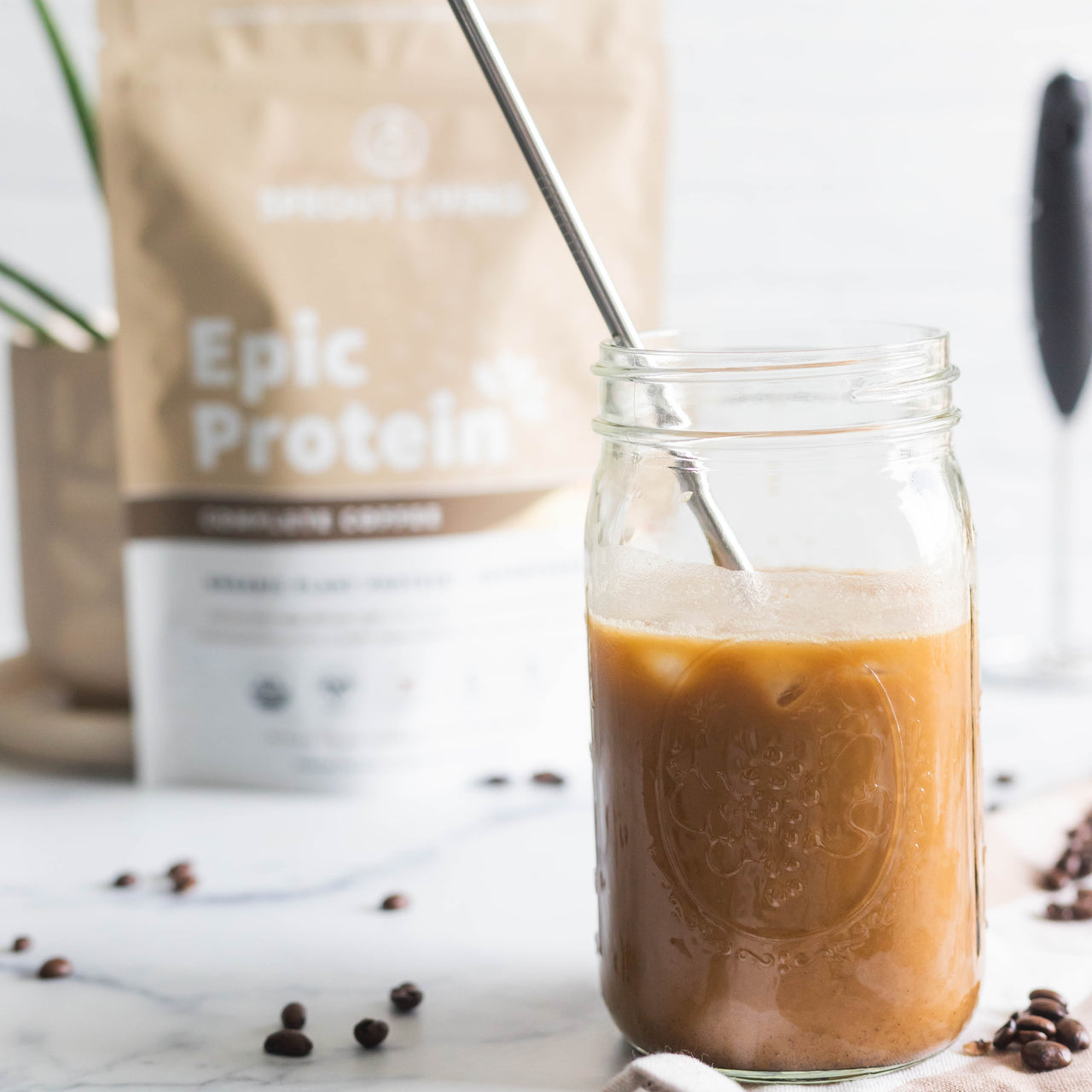 Pumpkin Spice Latte in glass with jar and Epic Complete Coffee 1lb bag