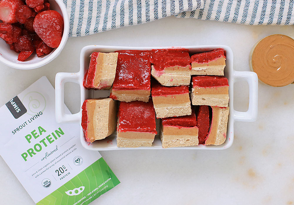 Peanut Butter and Jelly No-Bake Bars in dish with Simple Pea Protein packet