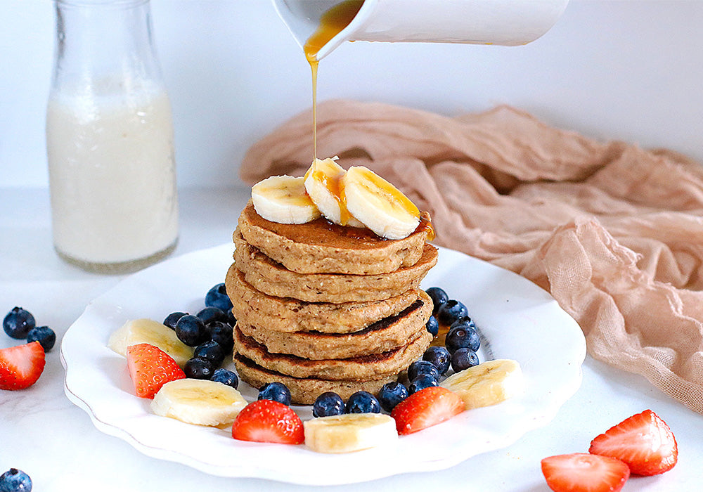 Protein Pancakes on plate with syrup being drizzled