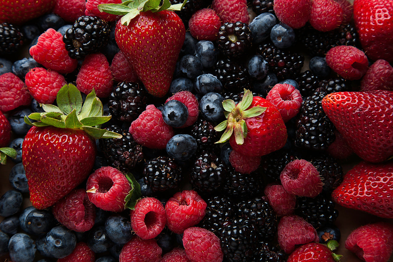 Strawberries, raspberries blueberries and blackberries in pile