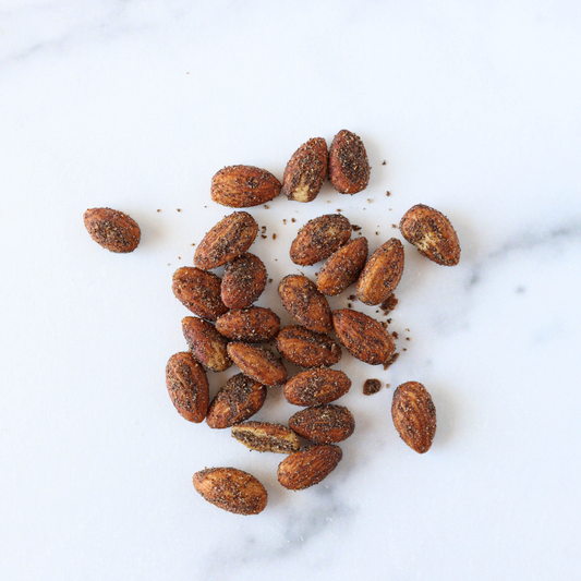 Spiced almonds on a white marble surface